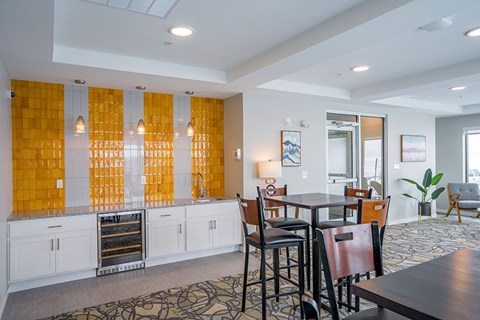 A kitchen with a dining table and chairs.