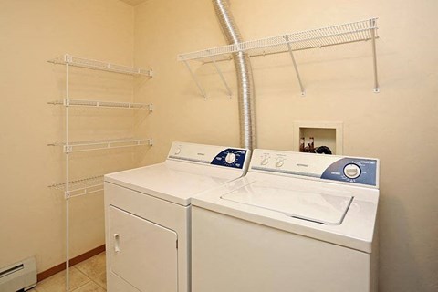 a laundry room with two washes and a dryer