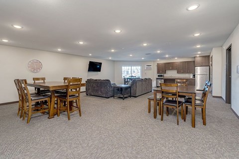 A dining room with a table and chairs.