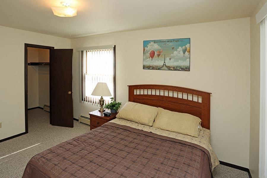 a bedroom with a bed and a door