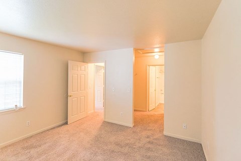 an empty living room with an open door