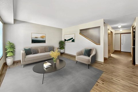 A living room with a grey sofa and a grey coffee table.