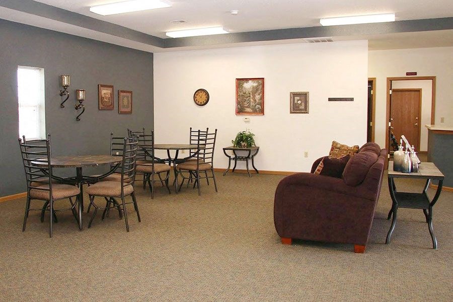 a living room with a couch and a table with chairs