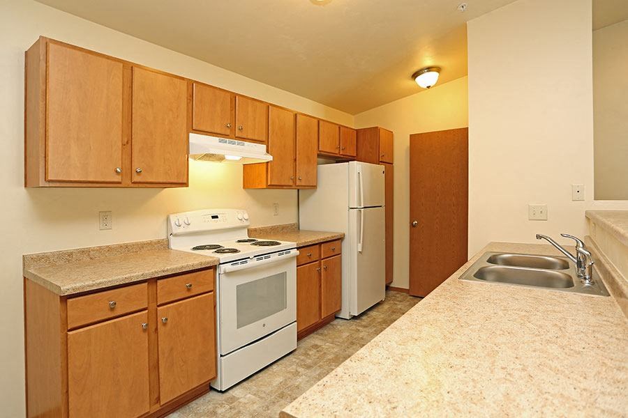a kitchen with a stove refrigerator and a sink