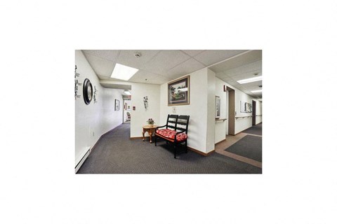 a hallway with a chair and a table in a building