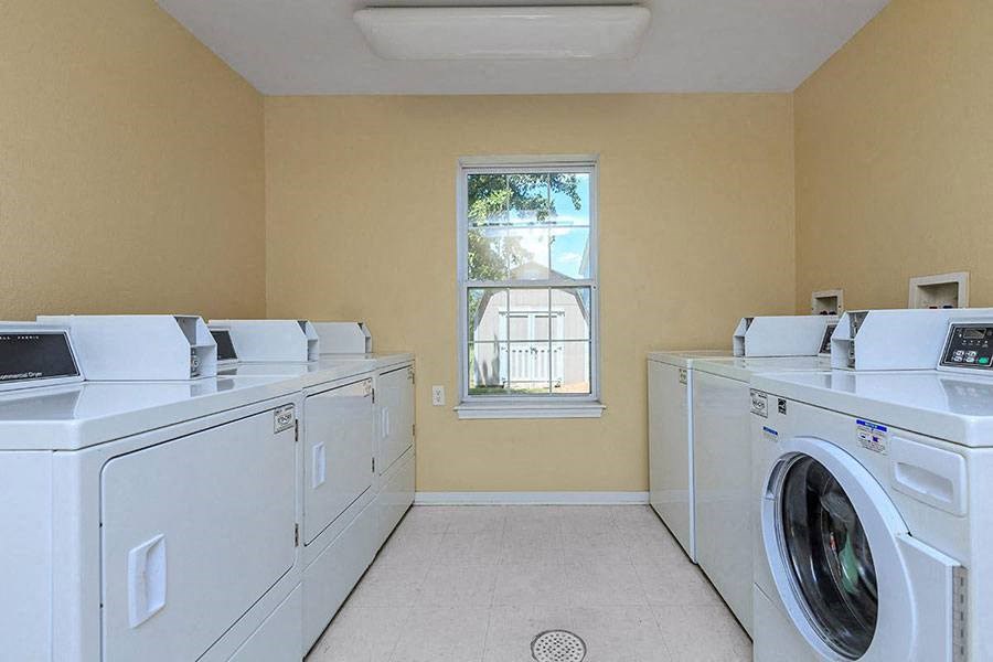 a laundry room filled with washes and dryers