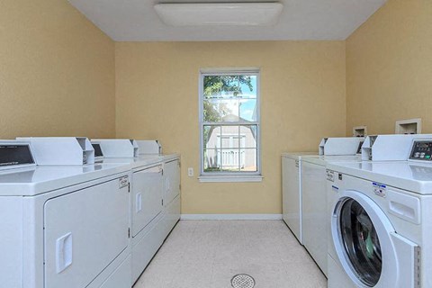 a laundry room filled with washes and dryers