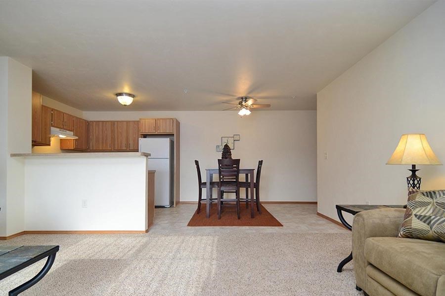A living room with a dining table and chairs.
