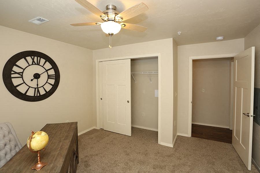 a room with a clock on the wall and a closet