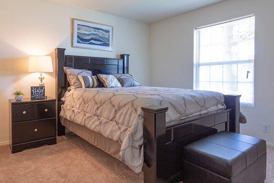 a bedroom with a large bed and a window