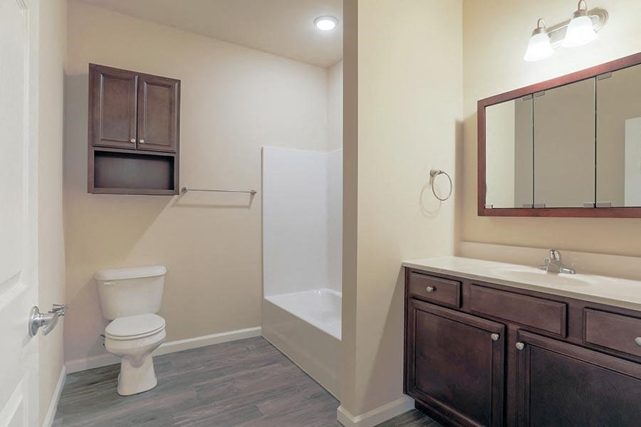 a bathroom with a toilet and a sink and a shower