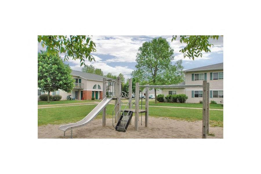 a playground with a slide in a park