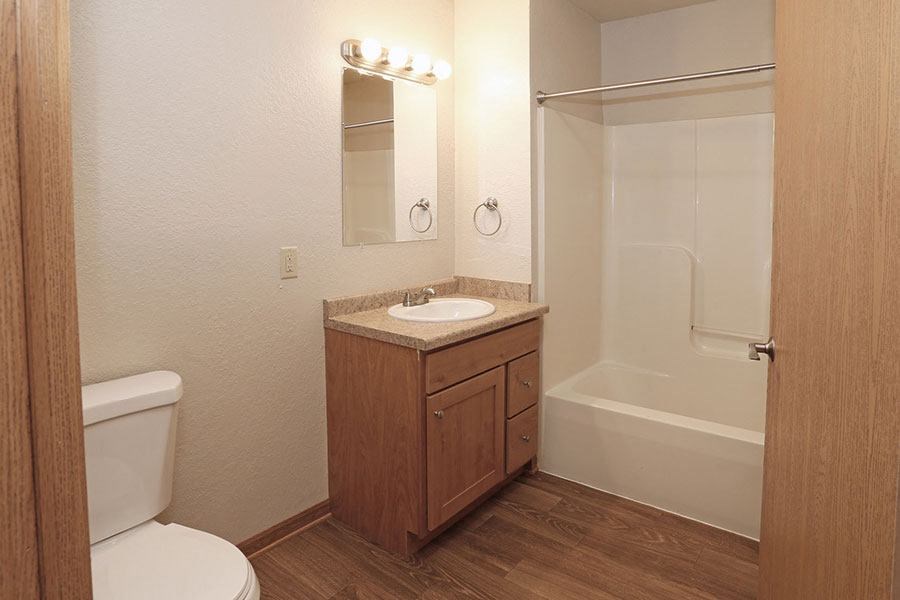 a bathroom with a toilet and a sink and a shower