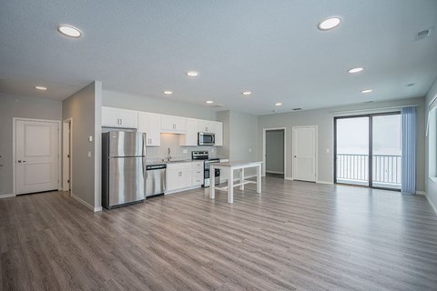 A spacious kitchen with a refrigerator, microwave, and oven.