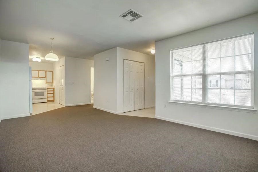 an empty living room with a large window