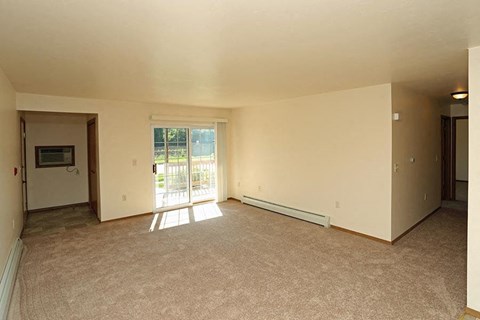 an empty living room with a sliding glass door