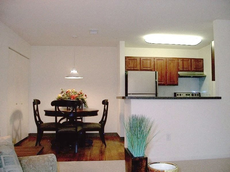 a kitchen and dining room with a table and chairs
