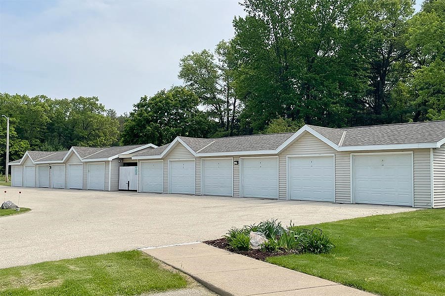 a row of white garages in a parking lot