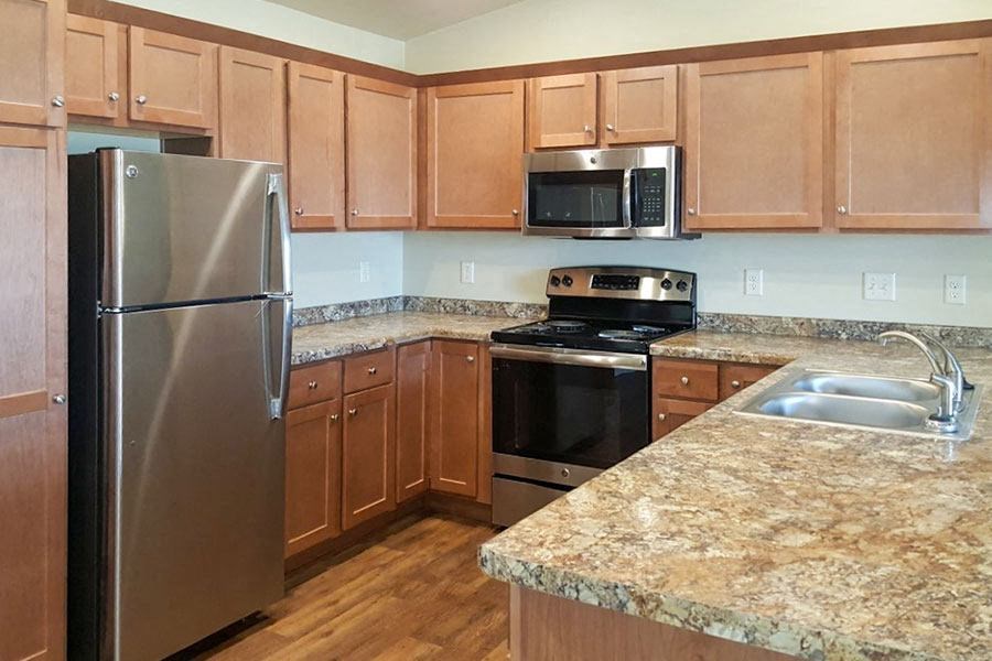 a kitchen with stainless steel appliances and granite counter tops