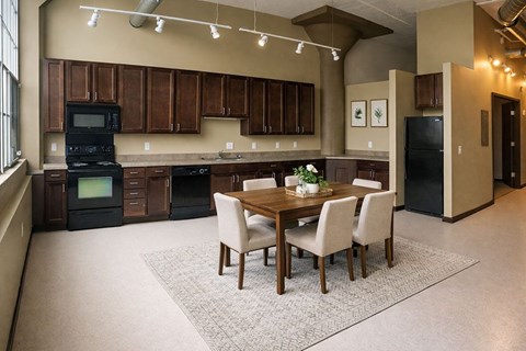 A kitchen with a table and chairs in the middle of the room.
