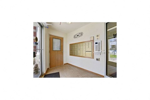 a room with a refrigerator and a door