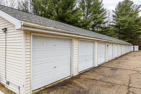 A long row of white garage doors are closed.