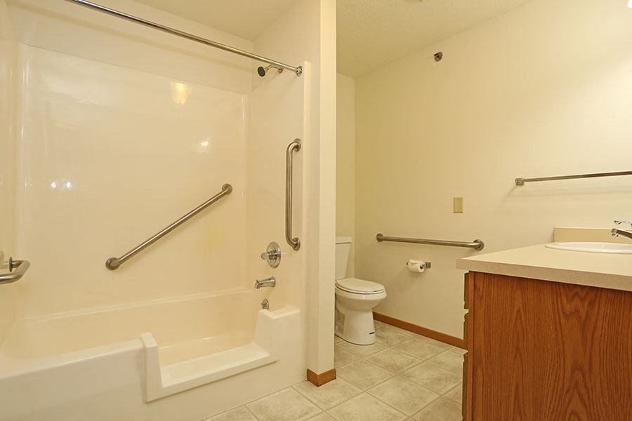 a bathroom with a shower and a toilet and a sink