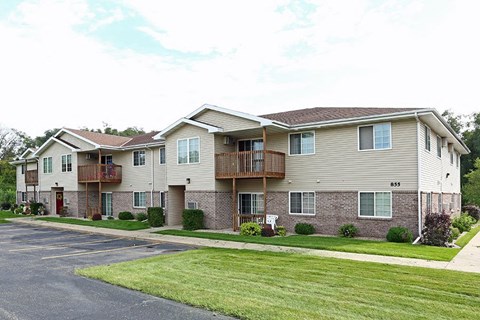 a row of houses with balconies on the side of a street