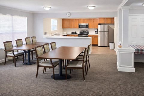 A dining room with a table and chairs.