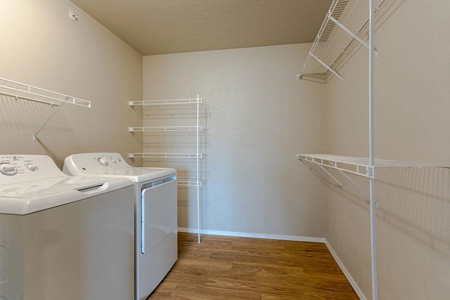 a laundry room with a washer and dryer and a closet