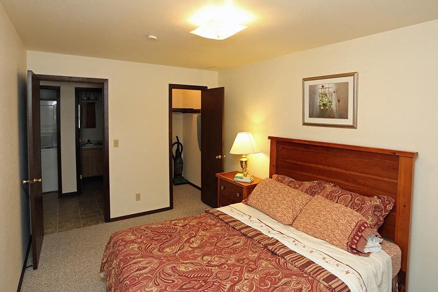 a hotel room with a bed and a mirror