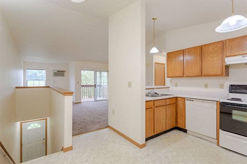 an empty kitchen with an empty living room