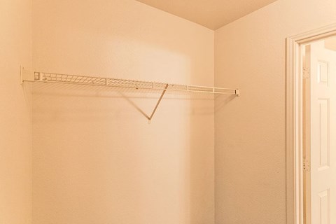 a empty closet with a rack on the wall