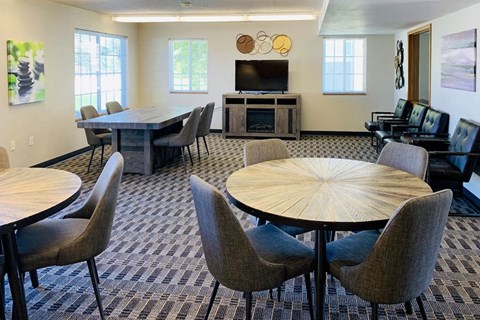 a conference room with tables and chairs and a television