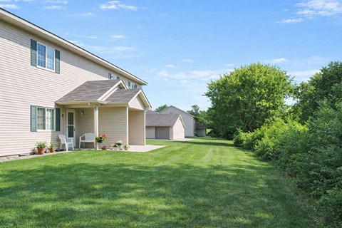 A house with a well-kept lawn in front.