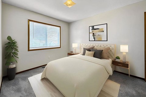 A bedroom with a large bed and a window.
