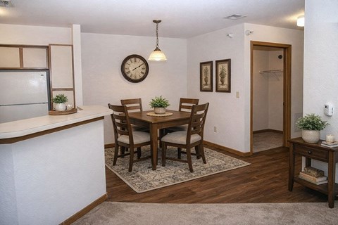 A dining room with a table set for four.