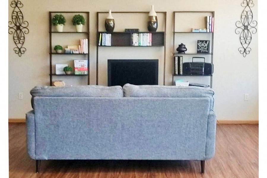 a blue couch in a living room with a fireplace