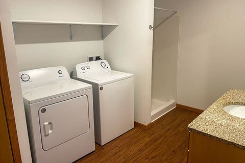A small bathroom with a sink and two toilets.