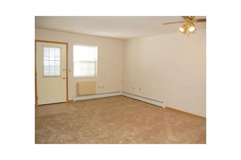 A room with a ceiling fan and a window.