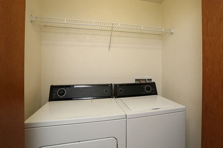A small laundry room with a washer and dryer.