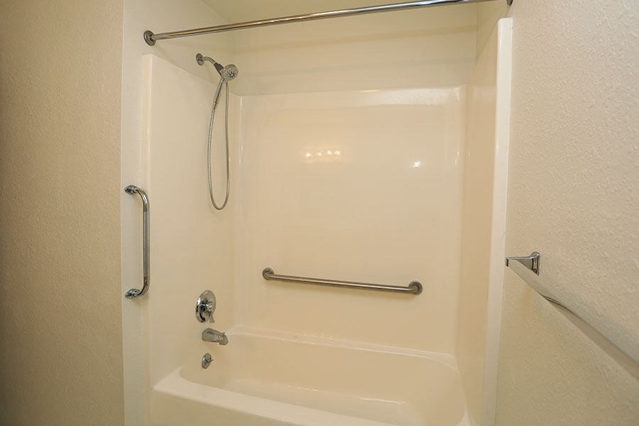 a bathroom with a shower and a bath tub