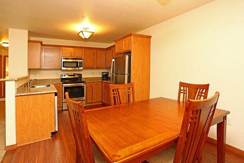 a kitchen and dining room with a wooden table