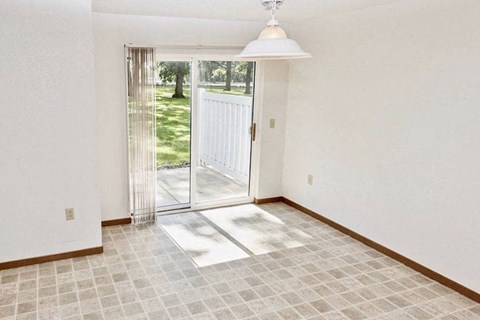 an empty living room with a sliding glass door