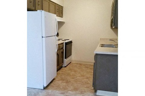 a kitchen with a stove and a refrigerator