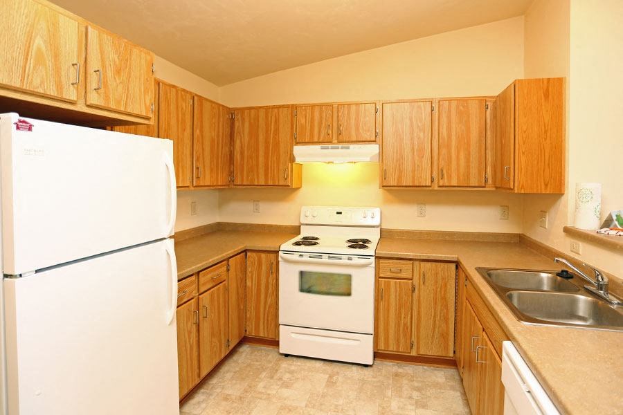 a kitchen with a stove refrigerator and a sink
