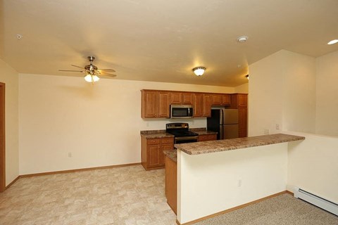 an empty kitchen with a counter top