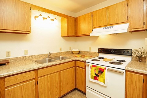 a kitchen with a stove top oven and a sink