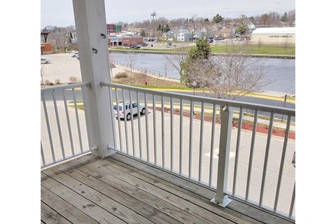 a balcony with a view of a lake and a car