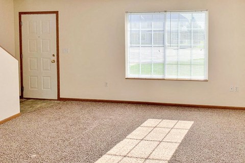 an empty room with a door and a window
